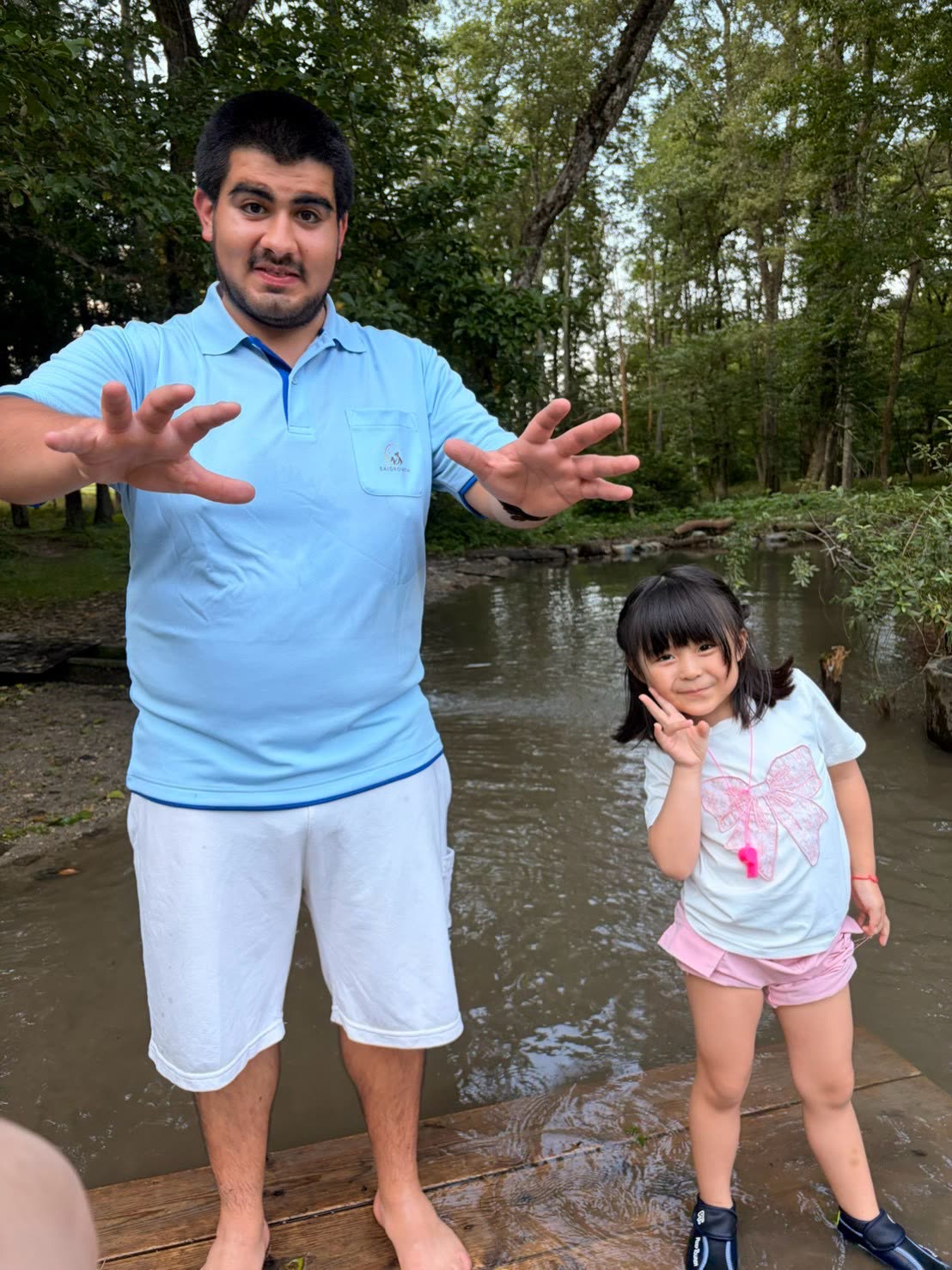 SAIGROWTH sitter with a child at a forest stream in Japan