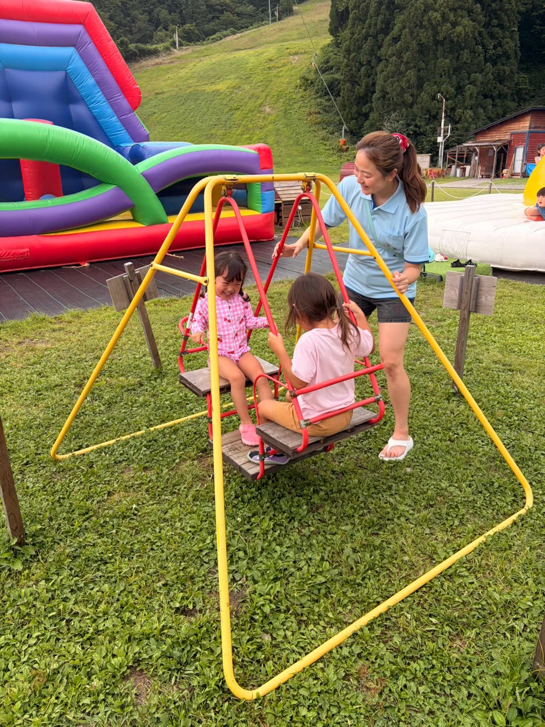 SAIGROWTH sitter playing on a swing with kids in Japan