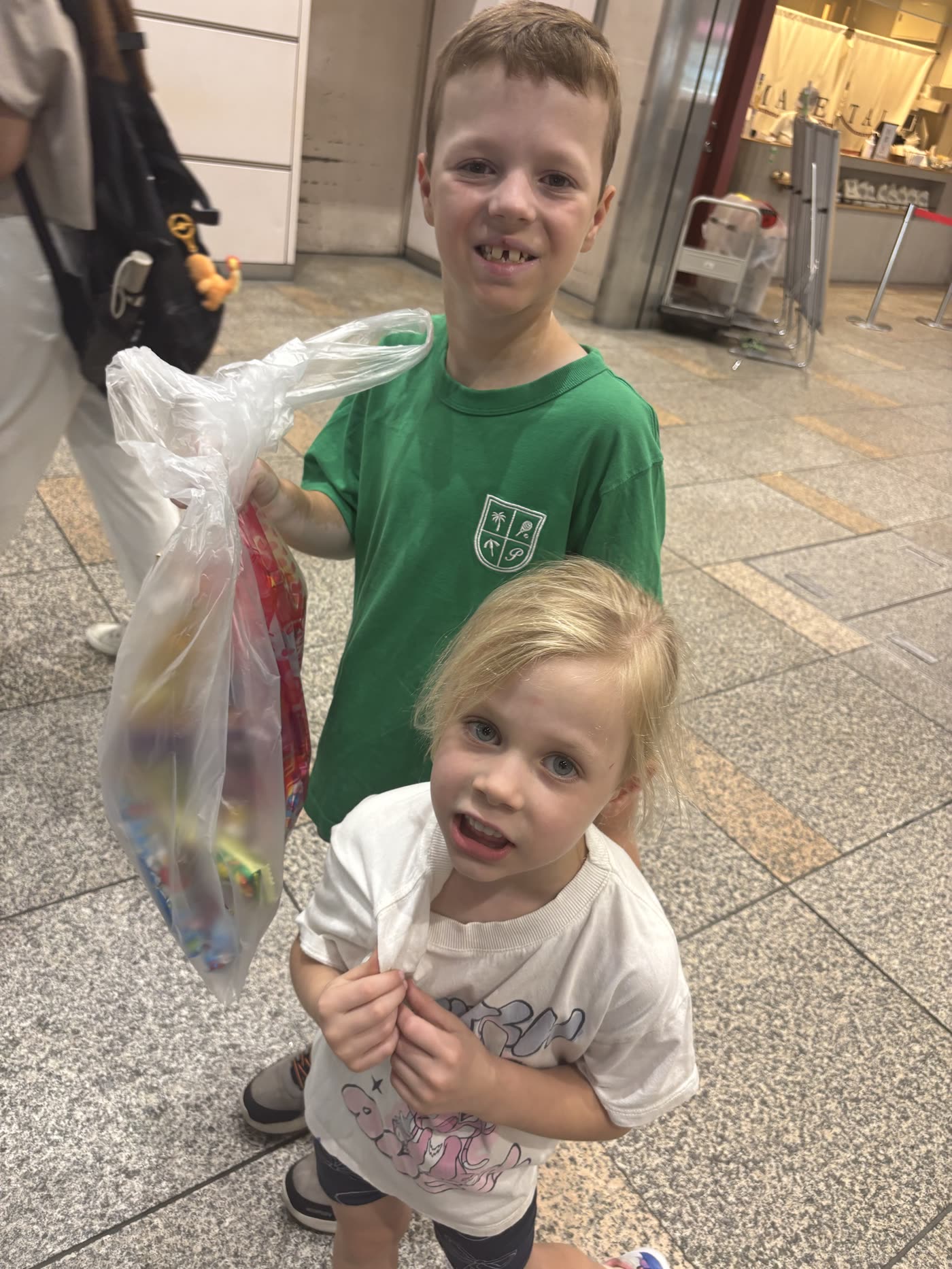 Kids with Japanese candy bag in Tokyo hotel lobby