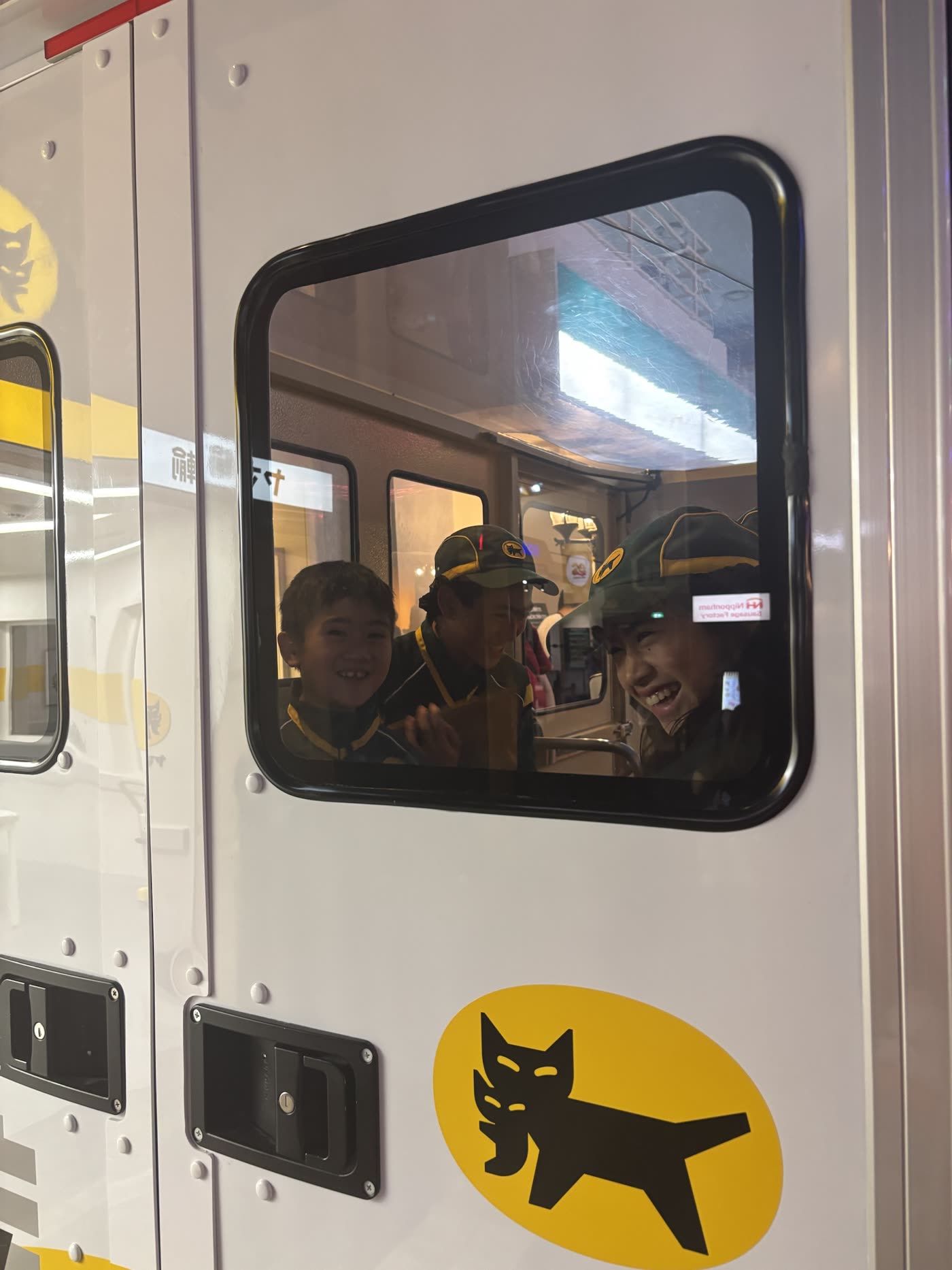 Kids in delivery uniforms at KidZania Tokyo — SAIGROWTH escort