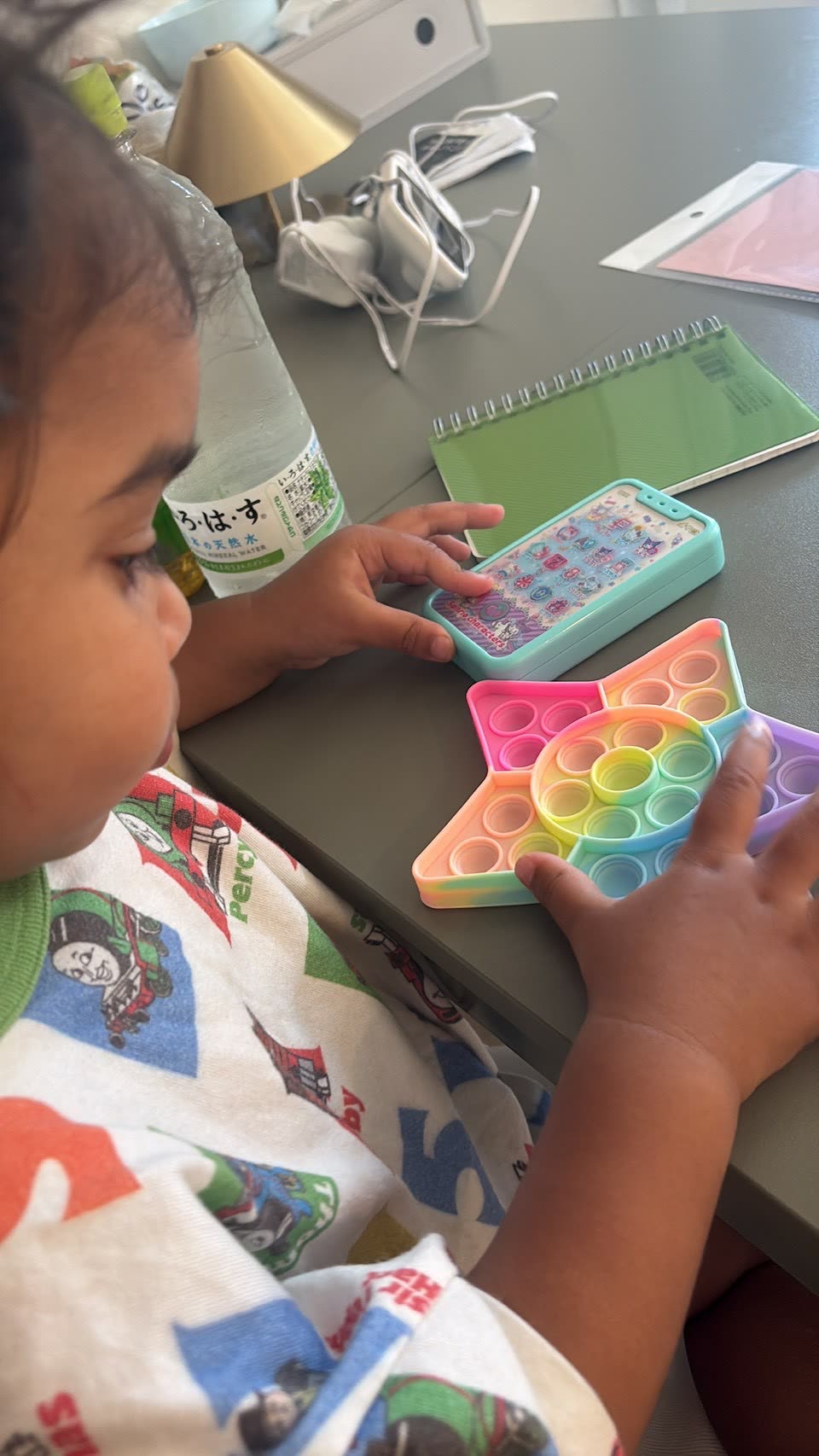 Toddler playing with a pop-it toy in Japan