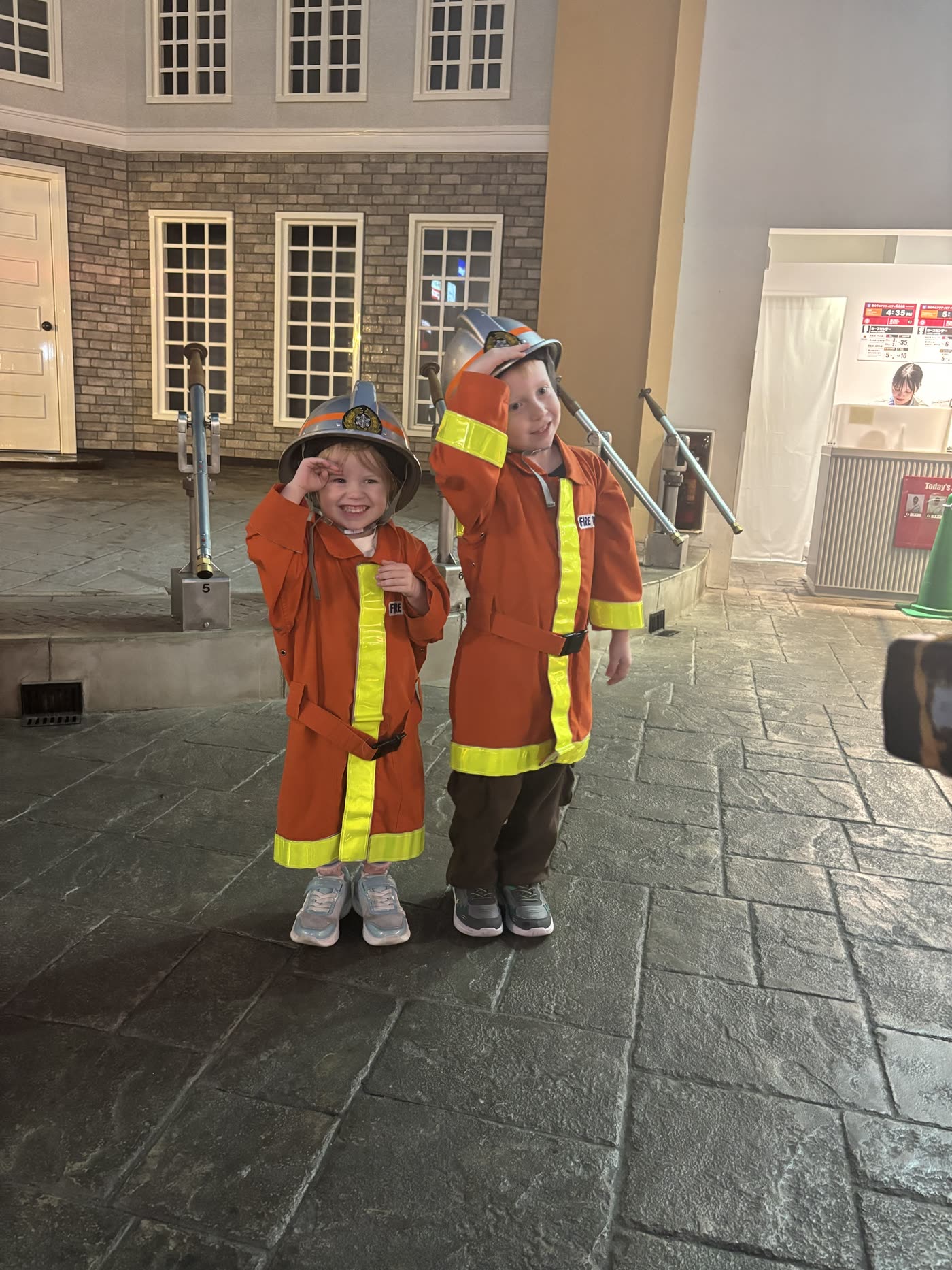 Sibling firefighters saluting at KidZania Tokyo